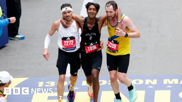 Strangers sacrifice personal records to carry struggling runner across Boston Marathon finish line
